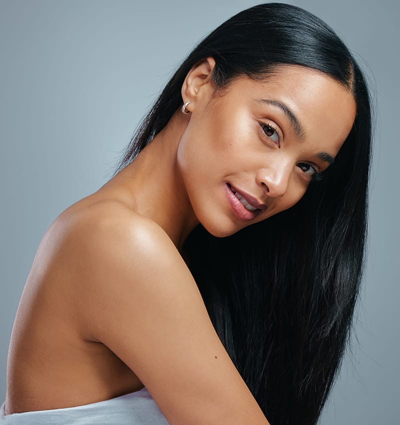 A woman with long black hair smiling at the camera.